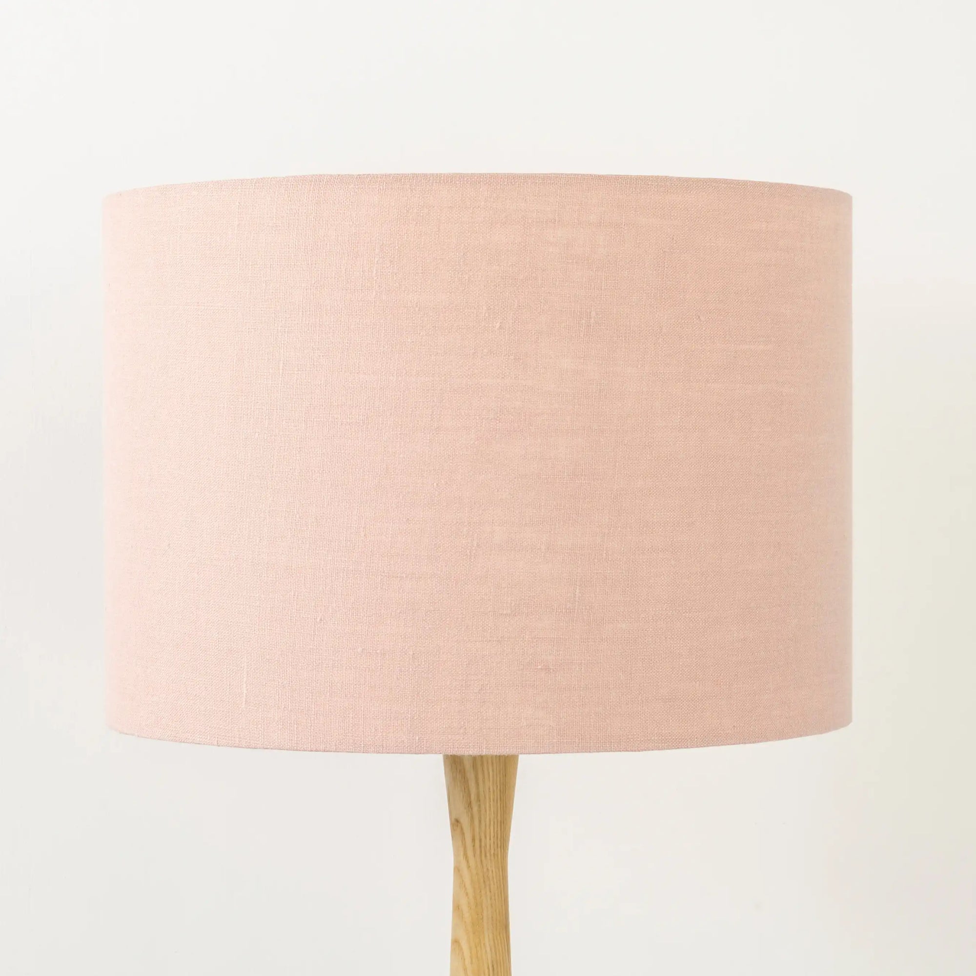 Blush pink lampshade on wooden table base