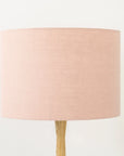 Blush pink lampshade on wooden table base