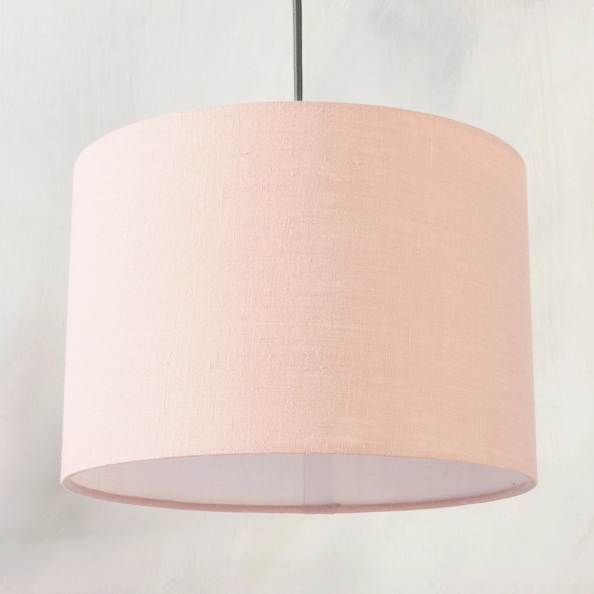 Blush pink pendant lampshade hanging from ceiling 