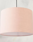 Blush pink pendant lampshade hanging from ceiling 